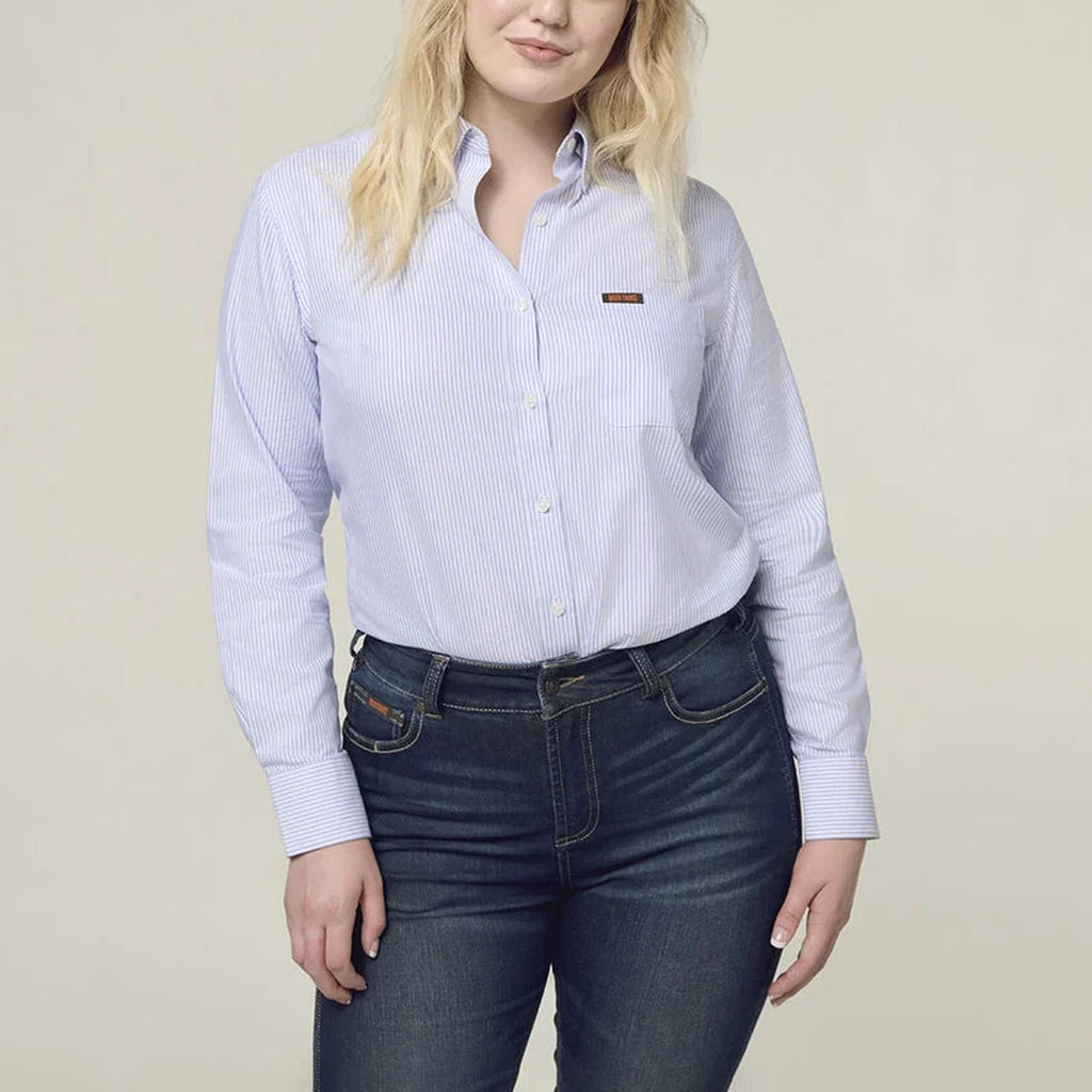 Person wearing a light blue striped Mustang Signature shirt and dark jeans.
