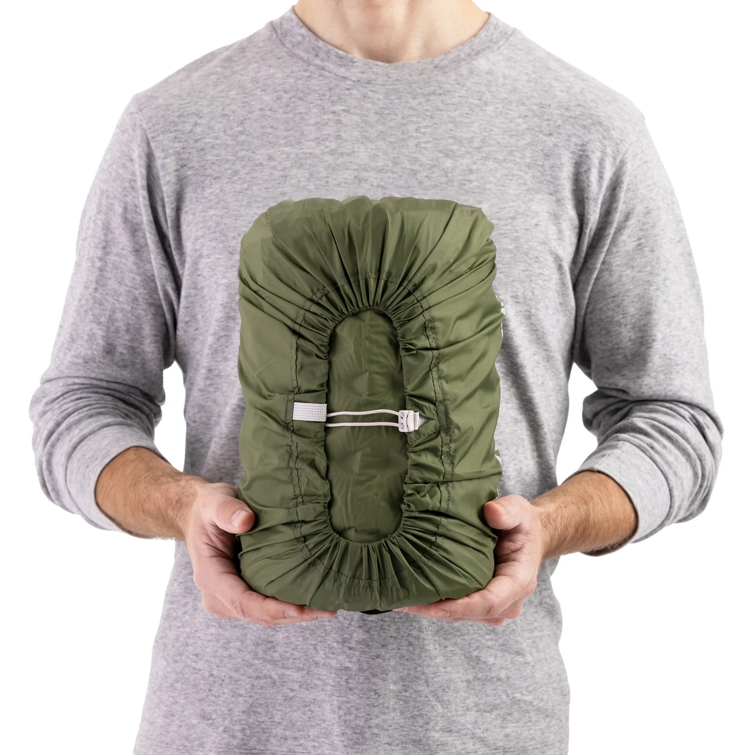 Man holding packed Sea to Summit green self inflating mat