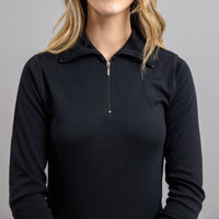 Woman wearing a black Merino Skins long sleeve top with a quarter zip