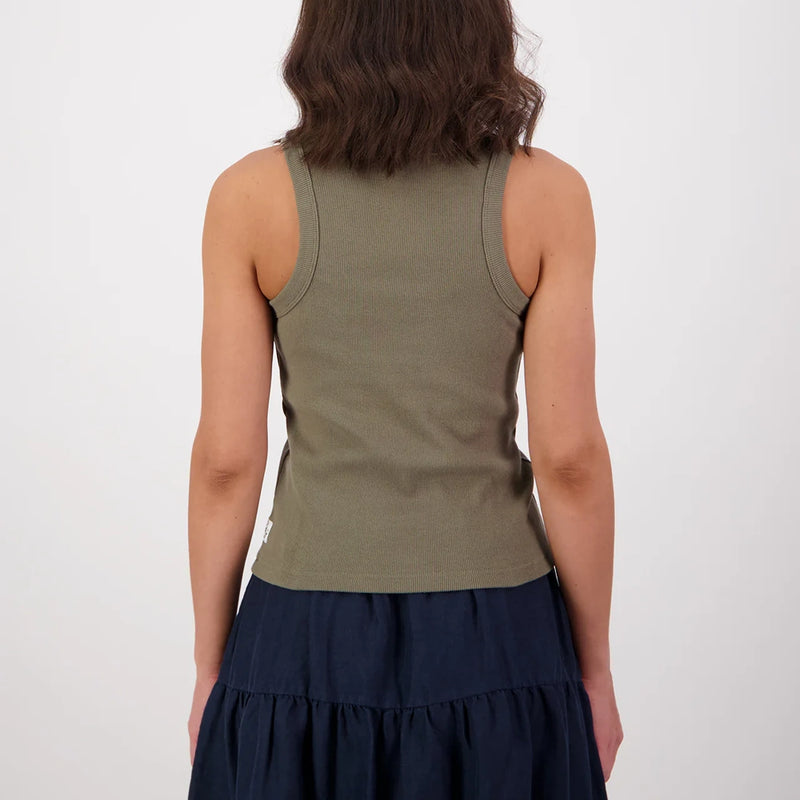 Person wearing a green tank top and navy skirt