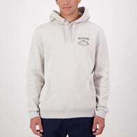 Person wearing a light grey Swanndri hoodie with a logo