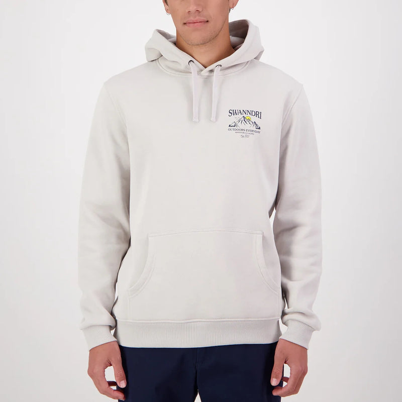Person wearing a light grey Swanndri hoodie with a logo