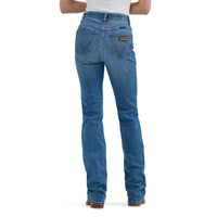 Blue Wrangler jeans worn by a person with a tucked in white t-shirt