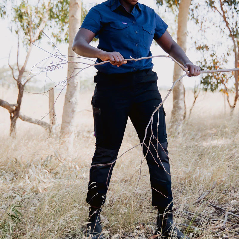 Model holding a stick in Green Hip Womens SKNY Flex Pants in Black