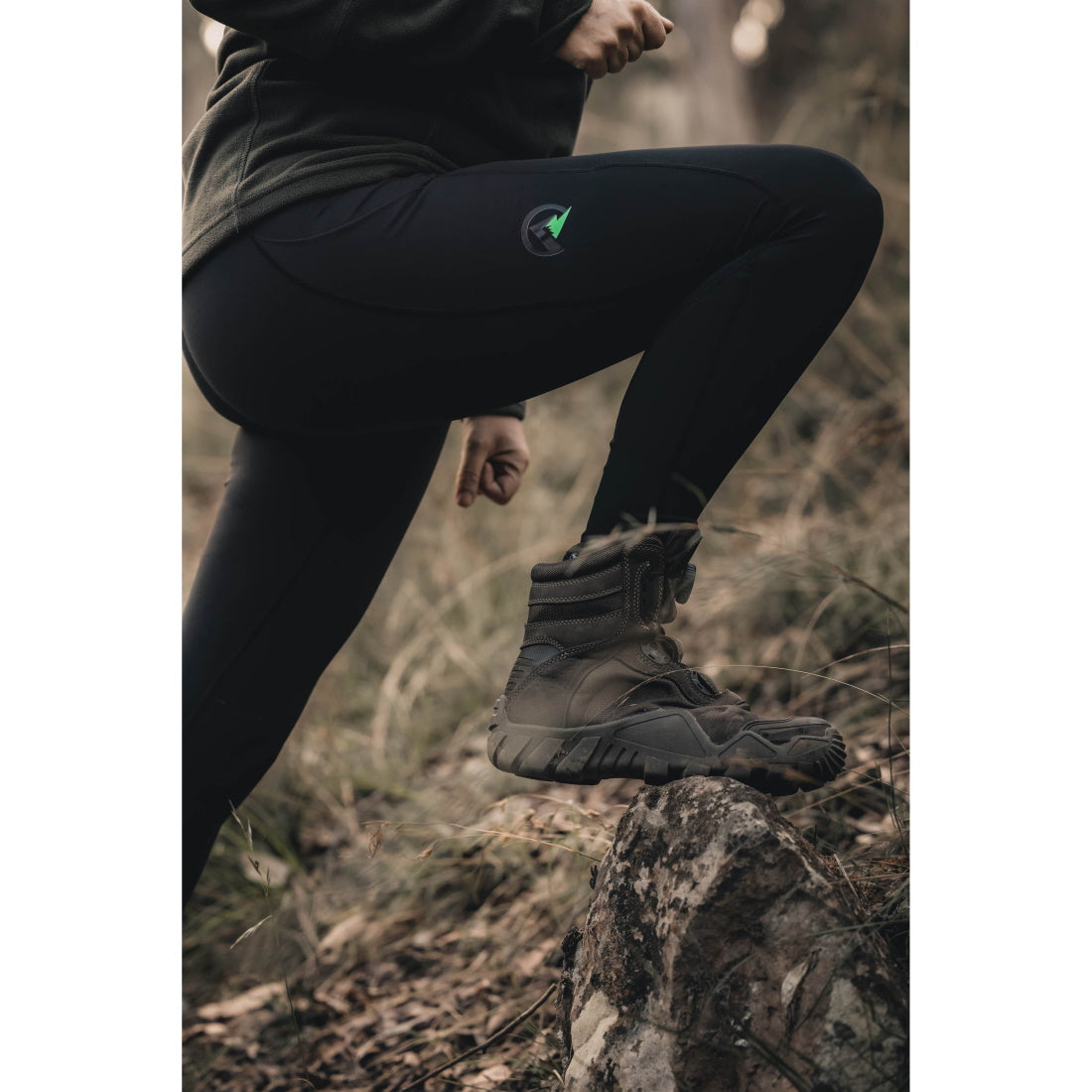 Woman climbing up rock in Ridgeline Womens Infinity Leggings