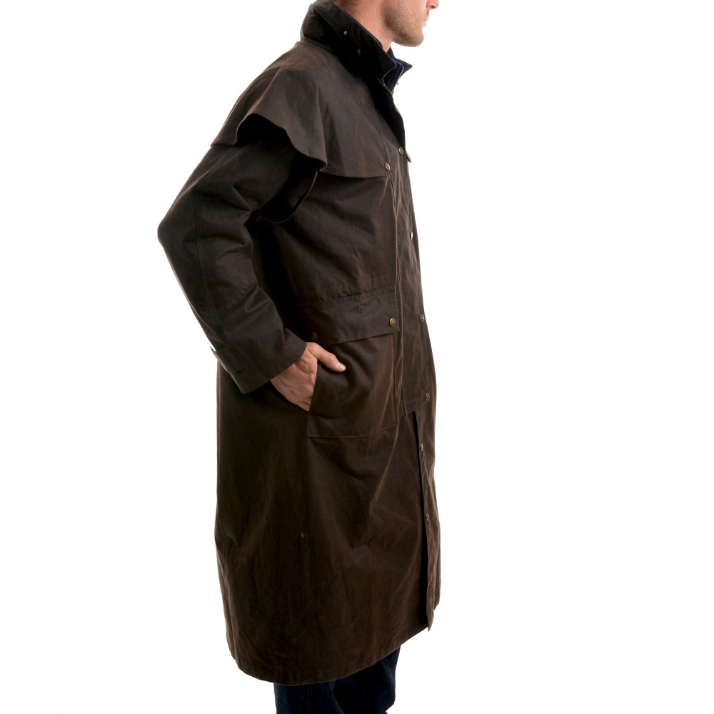 Side view of model wearing Thomas Cook High Country Professional Oilskin Long Coat in Brown