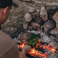 Man watching campfire grill