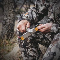 Man sharpening knife with Work Sharp Guided Field Sharpener